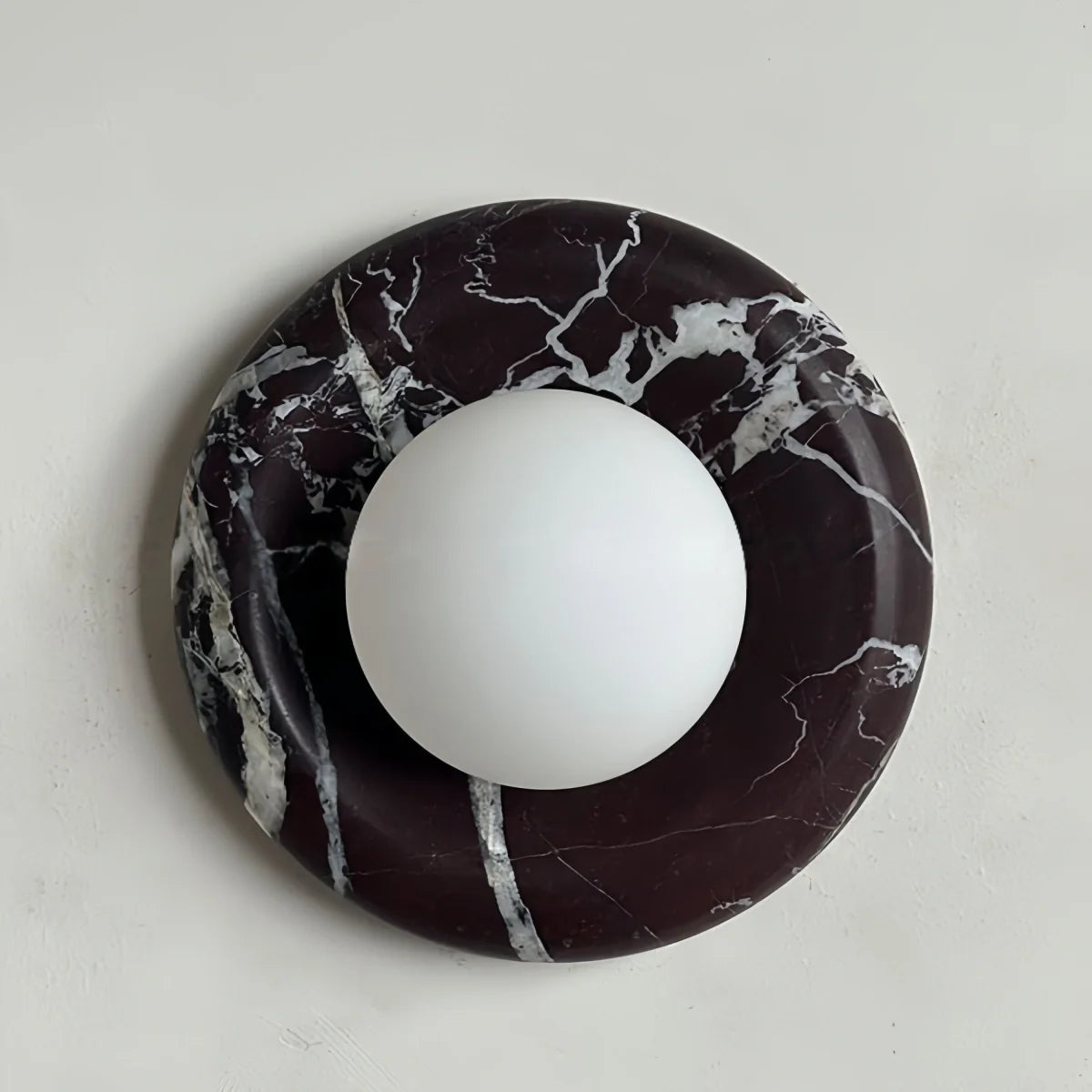 Natural travertine marble wall sconce with warm LED light and rustic textured design for bedroom and hallway lighting