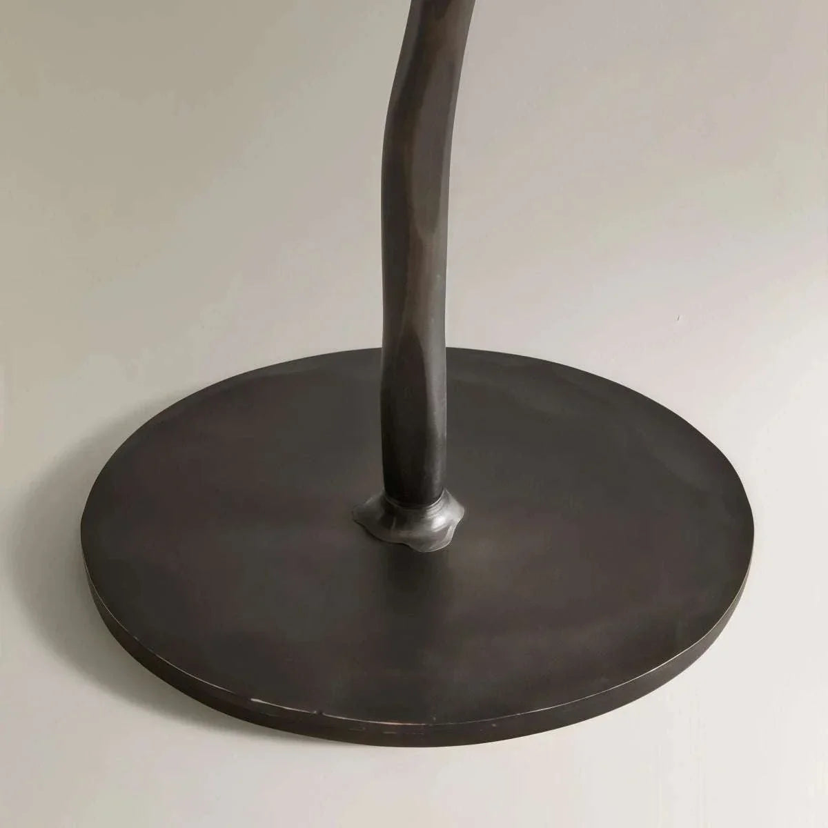 Matte black iron candelabra with classic European design holding taper branch candles on a tabletop display