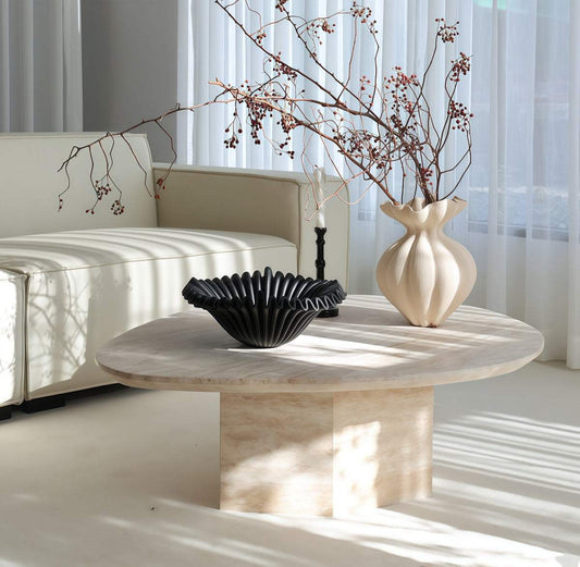 Natural Yellow Travertine coffee table with an irregular oval top, warm veining, and sturdy rectangular stone base