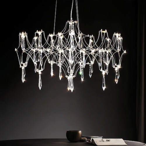 Stylish LED crystal chandelier illuminating a dining area with modern elegance - sparkledecor.com