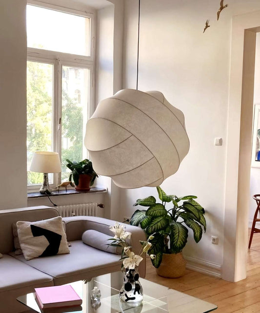 Wabi-Sabi silk pendant light with hand-crafted silk shade, warm diffused glow, and modern minimalist design in cozy living room.