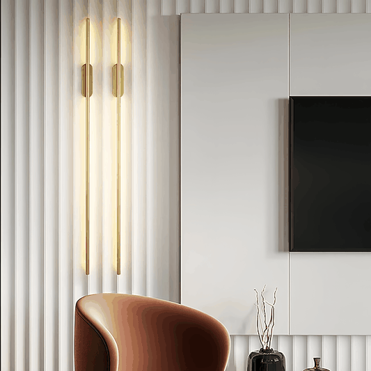 Pair of sleek modern wall lights in black and gold mounted beside a living room TV with ambient LED illumination