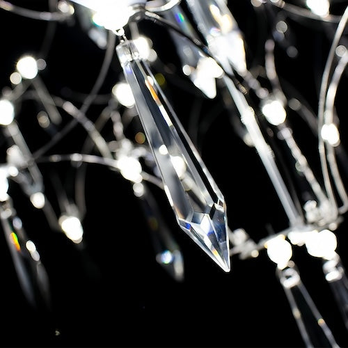 Stylish LED crystal chandelier illuminating a dining area with modern elegance - sparkledecor.com