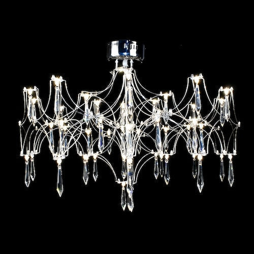 Stylish LED crystal chandelier illuminating a dining area with modern elegance - sparkledecor.com