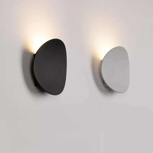 Modern oval LED wall lights in black and white, aluminum and glass, up-lighting for home decor