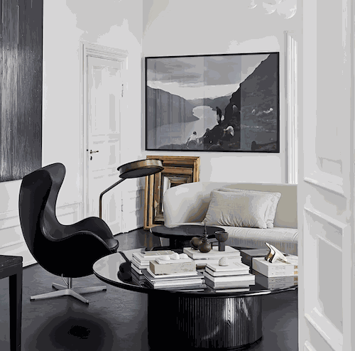 Black Egg Chair Replica by Arne Jacobsen with matching stool in modern living room setting