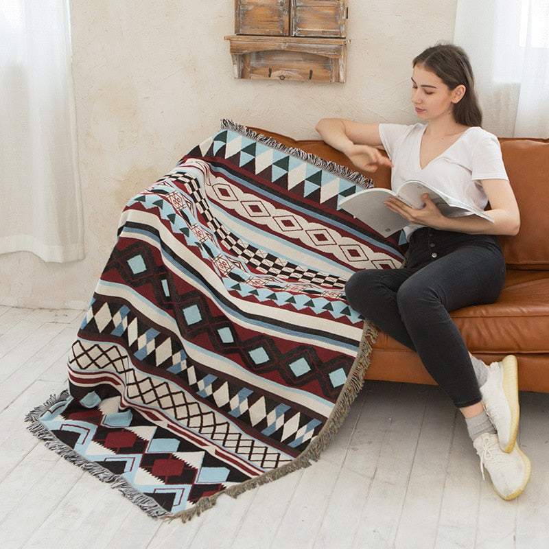 Quilted throw blanket with geometric plaid pattern, lightweight and soft, perfect for cozy relaxation at home or travel