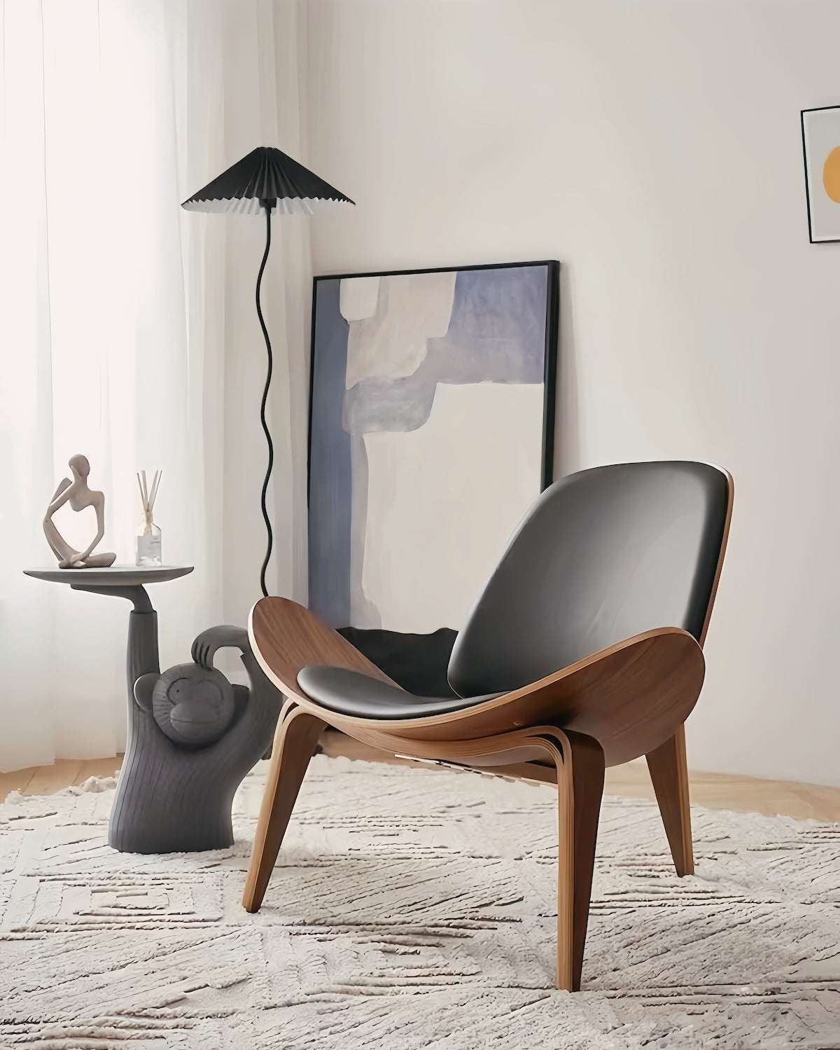 Elegant Shell Chair in black leather and walnut finish, featuring a curved silhouette and three-legged design for ergonomic comfort.