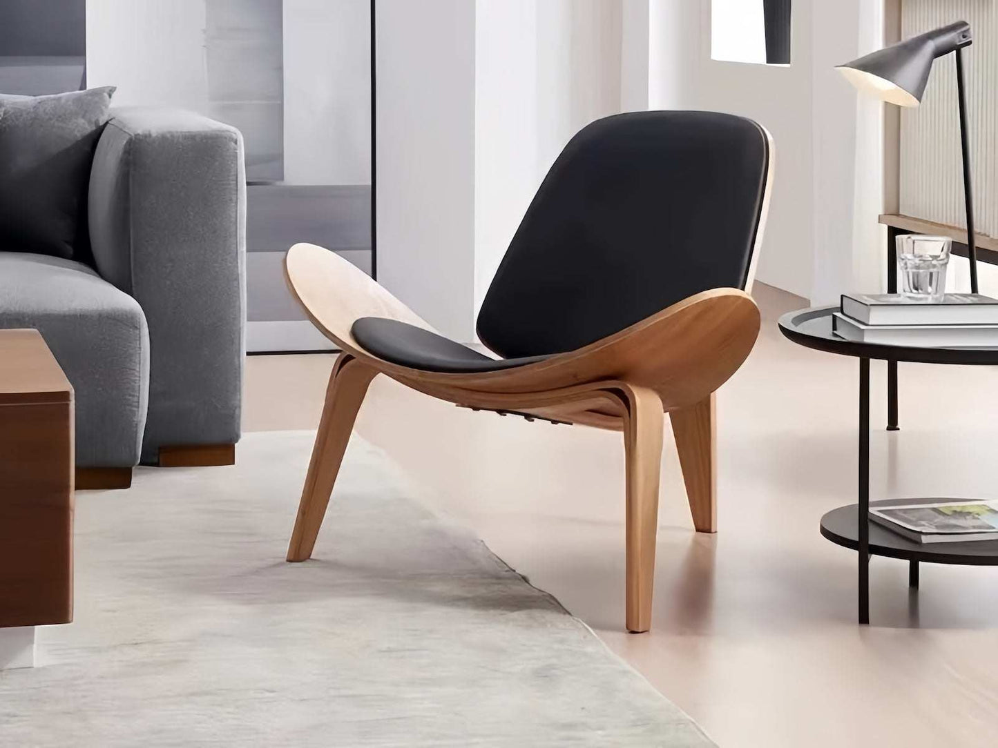 Shell Chair in black leather and walnut finish with ergonomic design.
