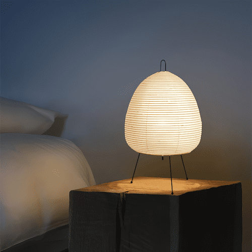 Traditional Japanese rice paper lamp on a wooden table, illuminating a cozy room - sparkledecor.com