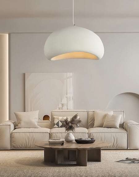 Wabi Sabi Pendant Light hanging in minimalist living room with beige sofa and wooden coffee table