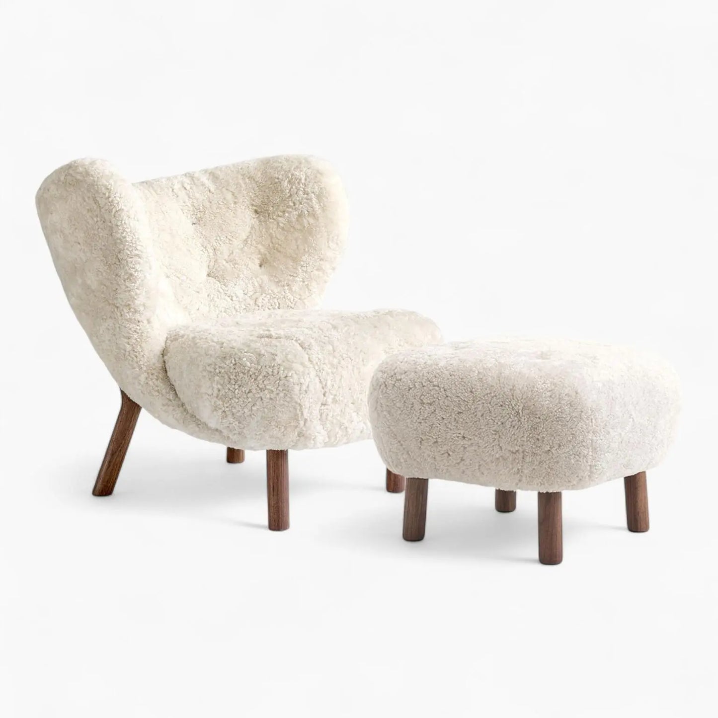 Little Petra Lounge Chair and Ottoman with faux sheepskin upholstery and cherry wood legs, embodying Danish design elegance.