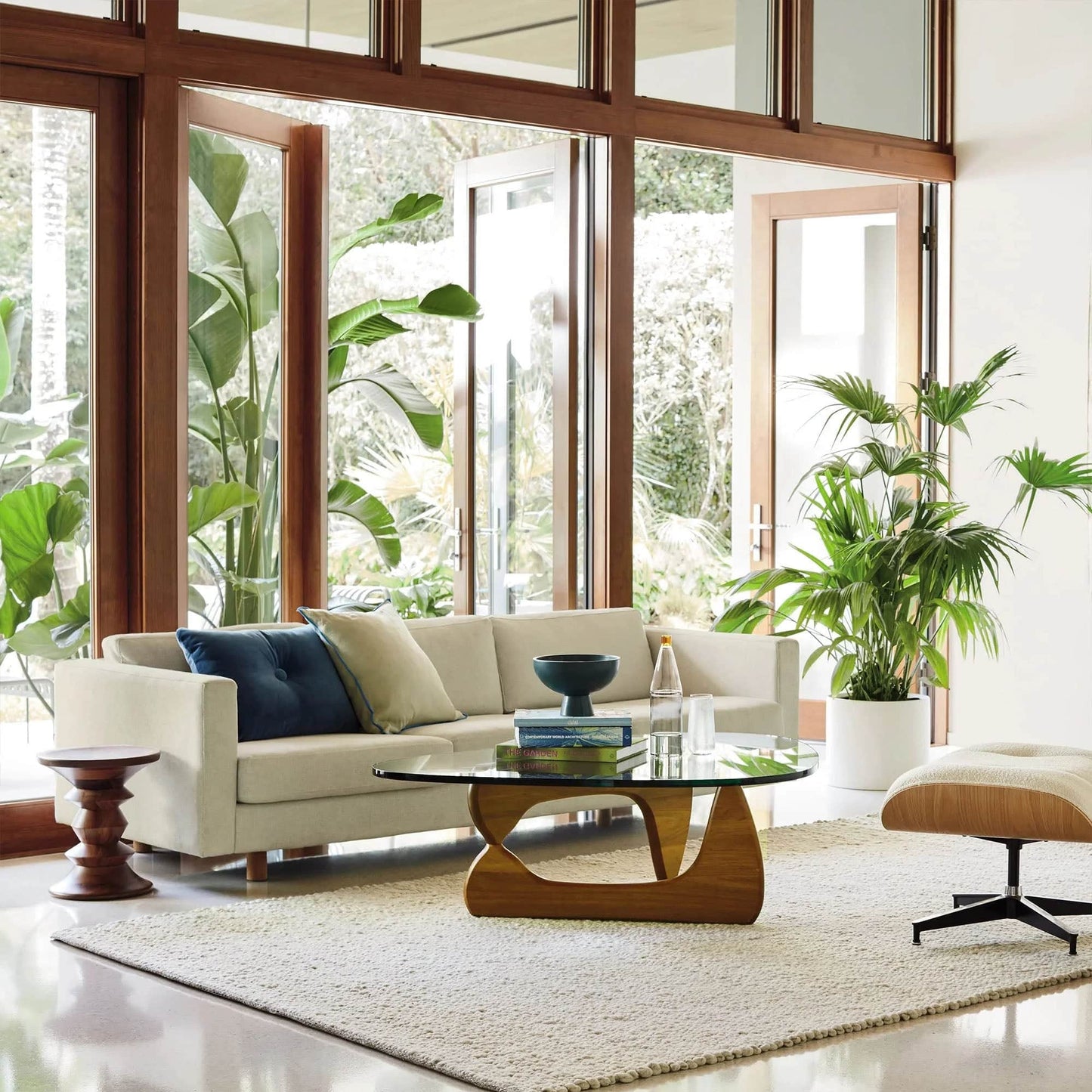 Noguchi Coffee Table in modern living room with glass top and wooden base - sparkledecor.com