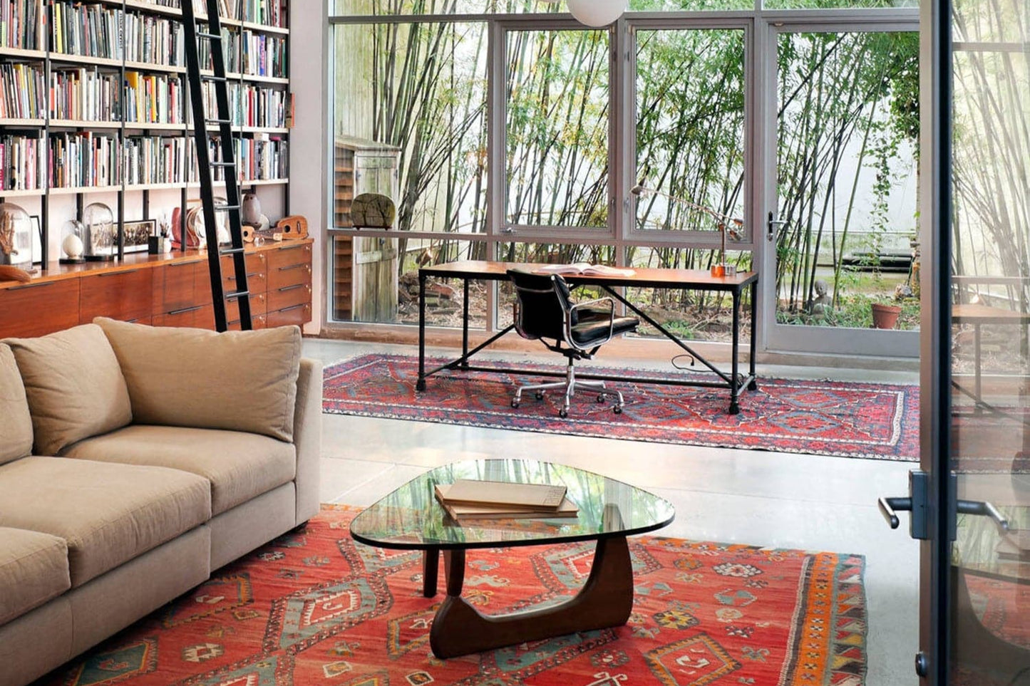 Noguchi Coffee Table in modern living space with bookshelf and large windows - sparkledecor.com