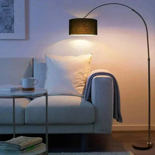Modern adjustable LED floor lamp with fabric shade in living room setting