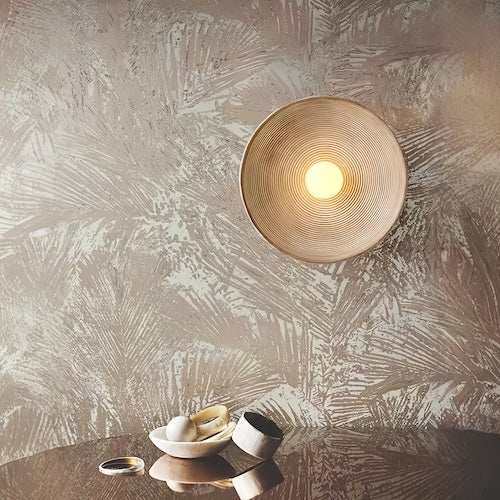 Rustic wood wall light fixture with warm LED glow mounted on textured wall above decorative table items