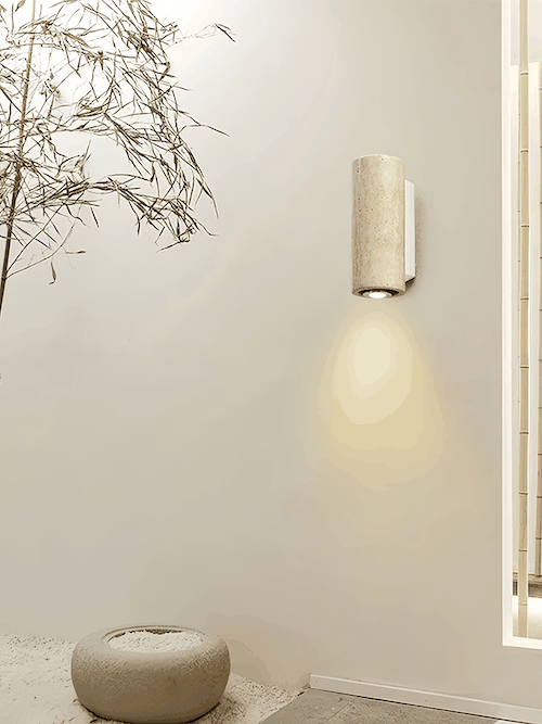 Contemporary travertine stone wall light with warm ambient LED glow for indoor living spaces