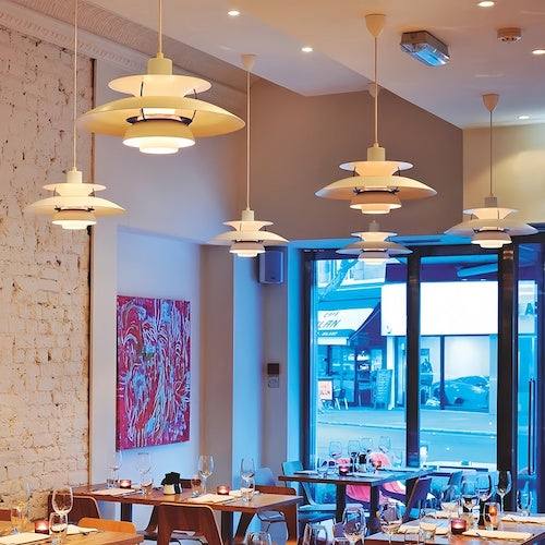 Scandinavian style kitchen island pendant lighting with sandblasted shades illuminating dining area