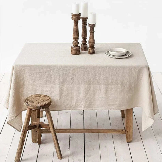 Rectangle tablecloth in beige 100% pure linen on rustic wooden table with candles and stool