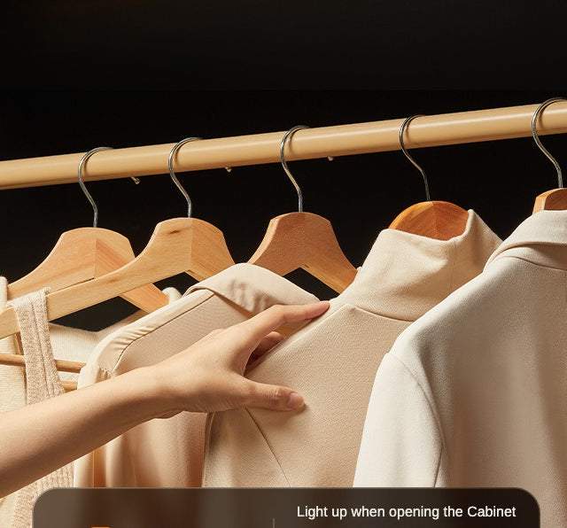 Motion Sensor Night Light illuminating clothes inside a cabinet when opened, showcasing easy and automatic lighting solution.