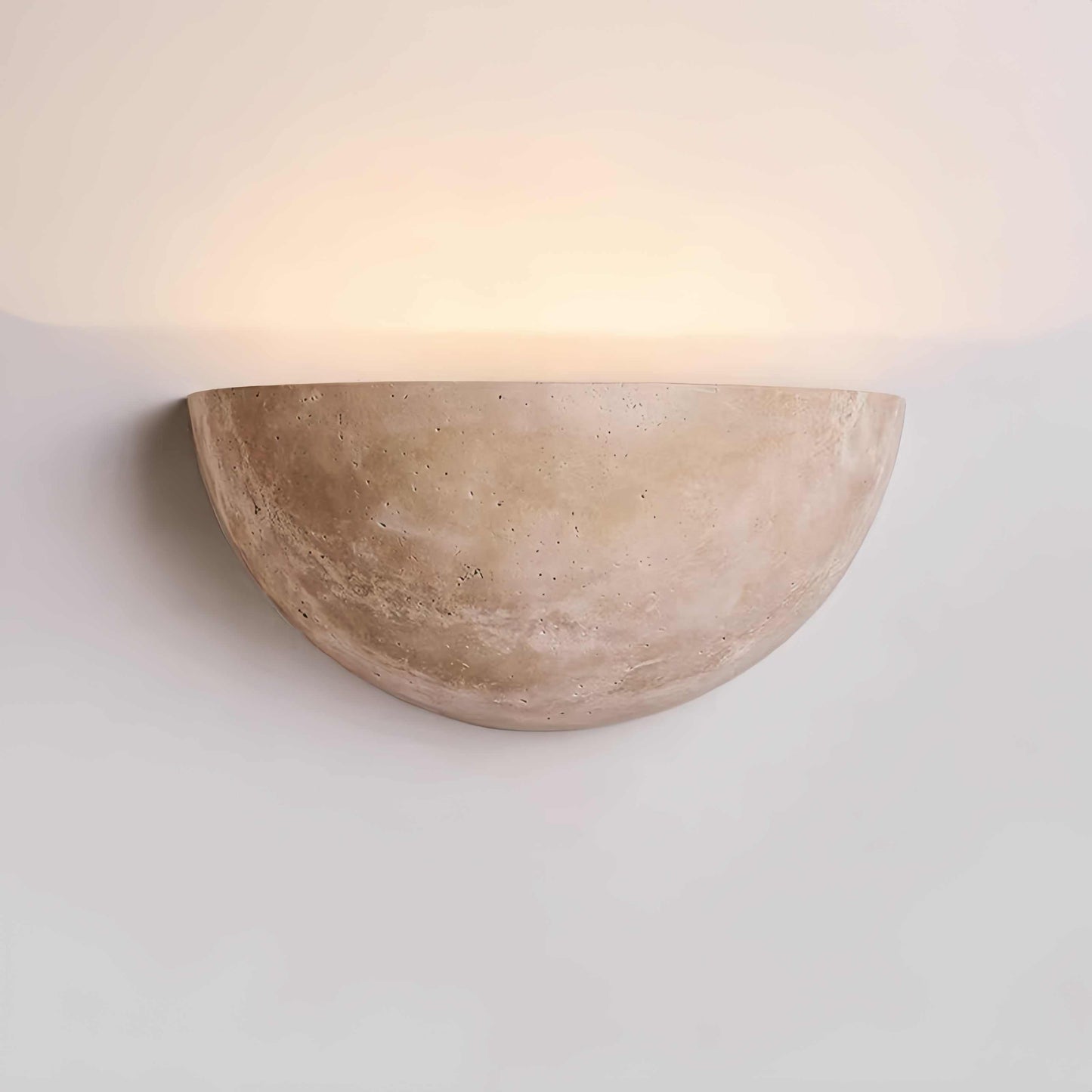 Vintage Wabi-Sabi style wall sconce made of natural off-white travertine with soft light and seamless design
