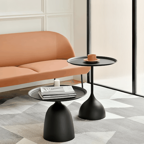 Set of modern black side tables with round metal design in living room