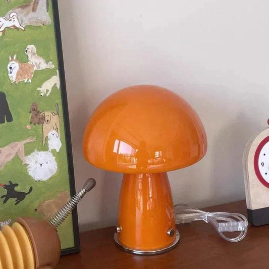 Orange mushroom-shaped bedside table lamp with USB charging on wooden surface