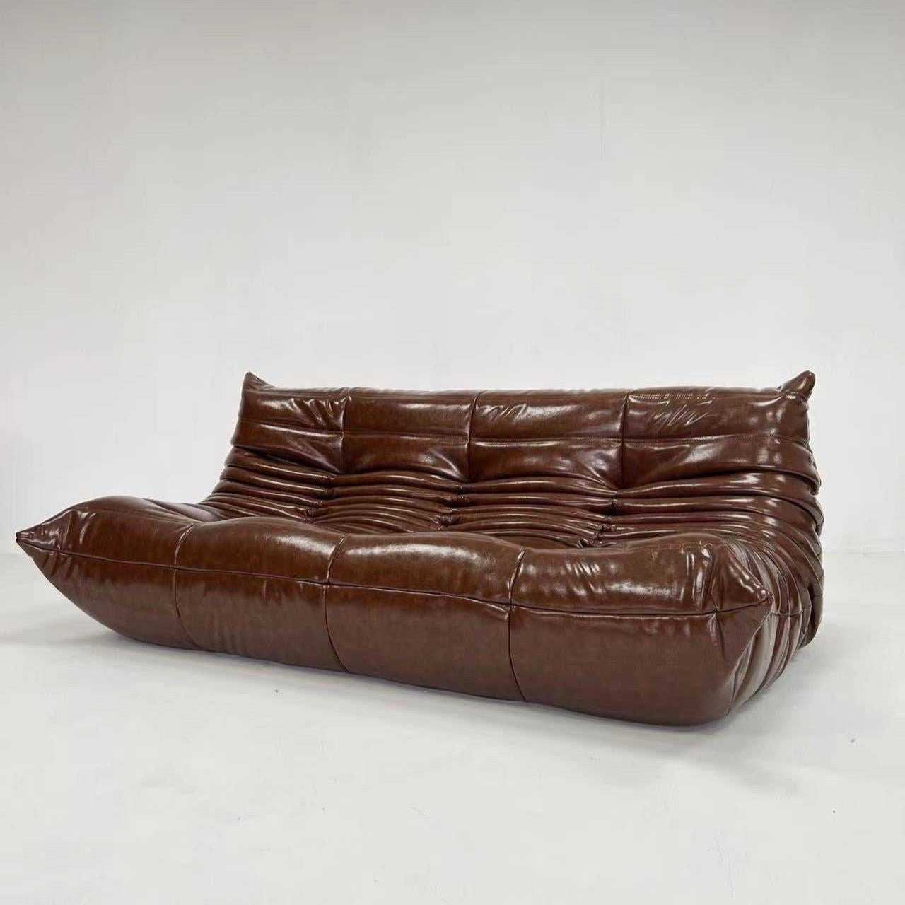 Ligne Roset Togo sofa replica in dark brown oil wax leather with ergonomic tufted design and plush cushioning