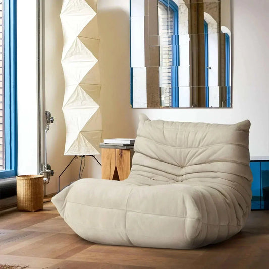 Beige Togo Chair lounge chair with plush cushions in modern living room setting
