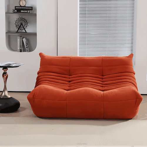 Modern orange suede loveseat sofa with ergonomic design and plush cushioning in stylish living room setting