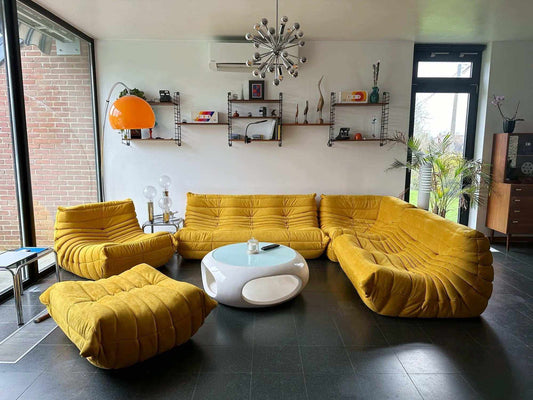 Yellow Togo Couch 3-Seater with matching armchair and ottoman in modern living room setting