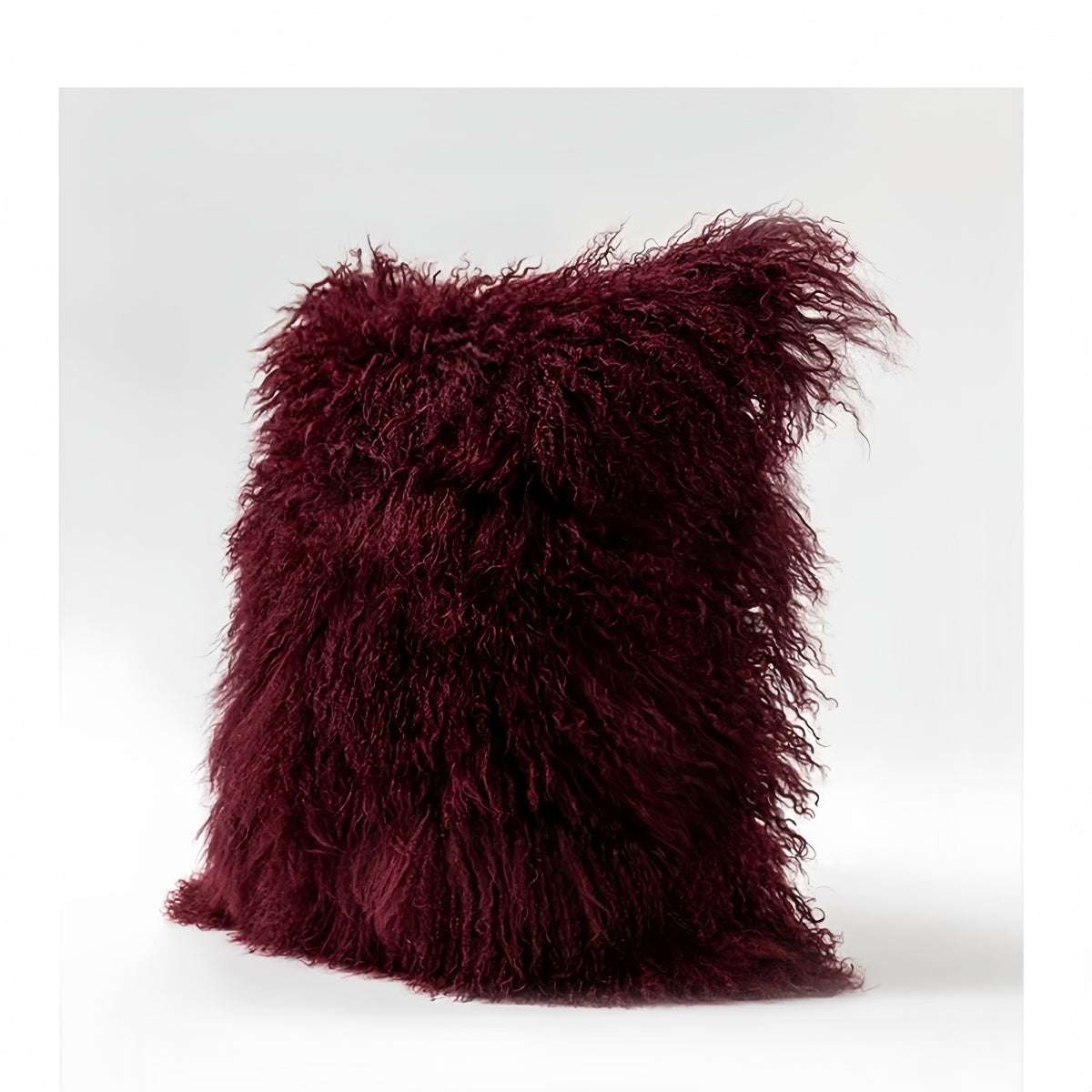 Modern burgundy lamb wool sofa cushion with plush texture and minimalist design
