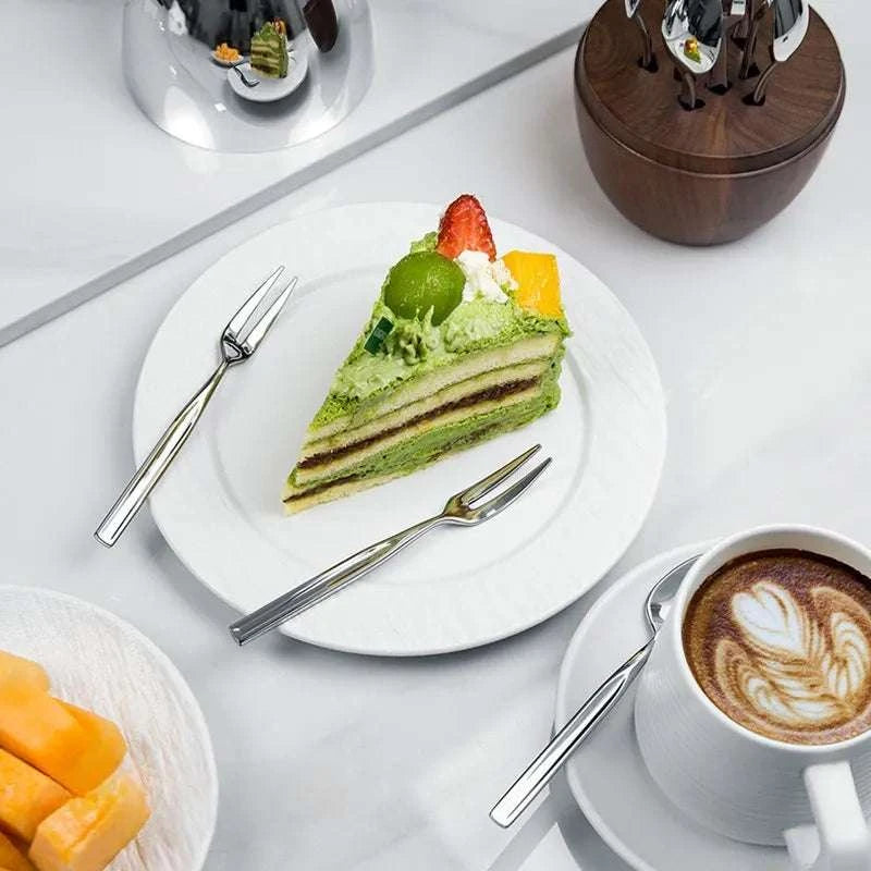 Light luxury tableware storage box with solid walnut base and polished stainless steel shell holding coffee spoons and dessert forks for elegant home decor and gifting