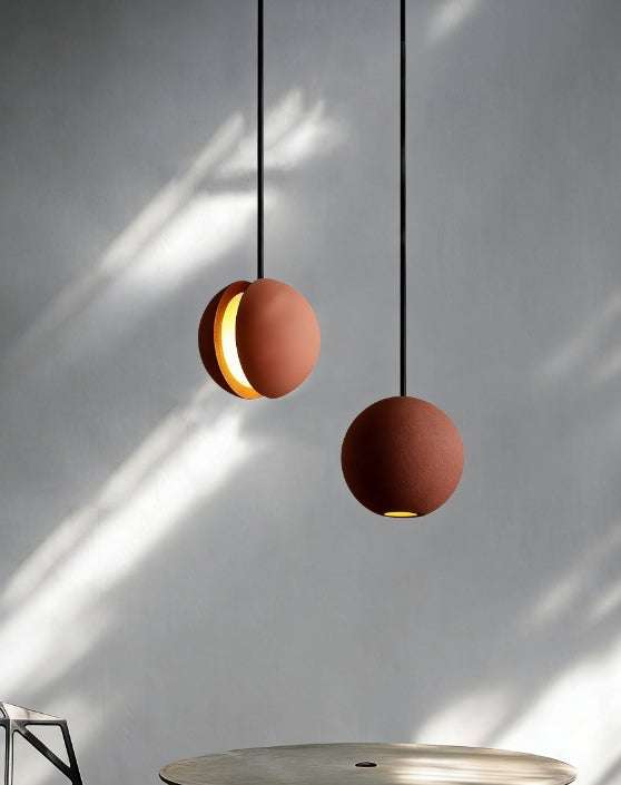 Concrete moon pendant light with industrial fish-shaped stone design and warm LED ambient lighting