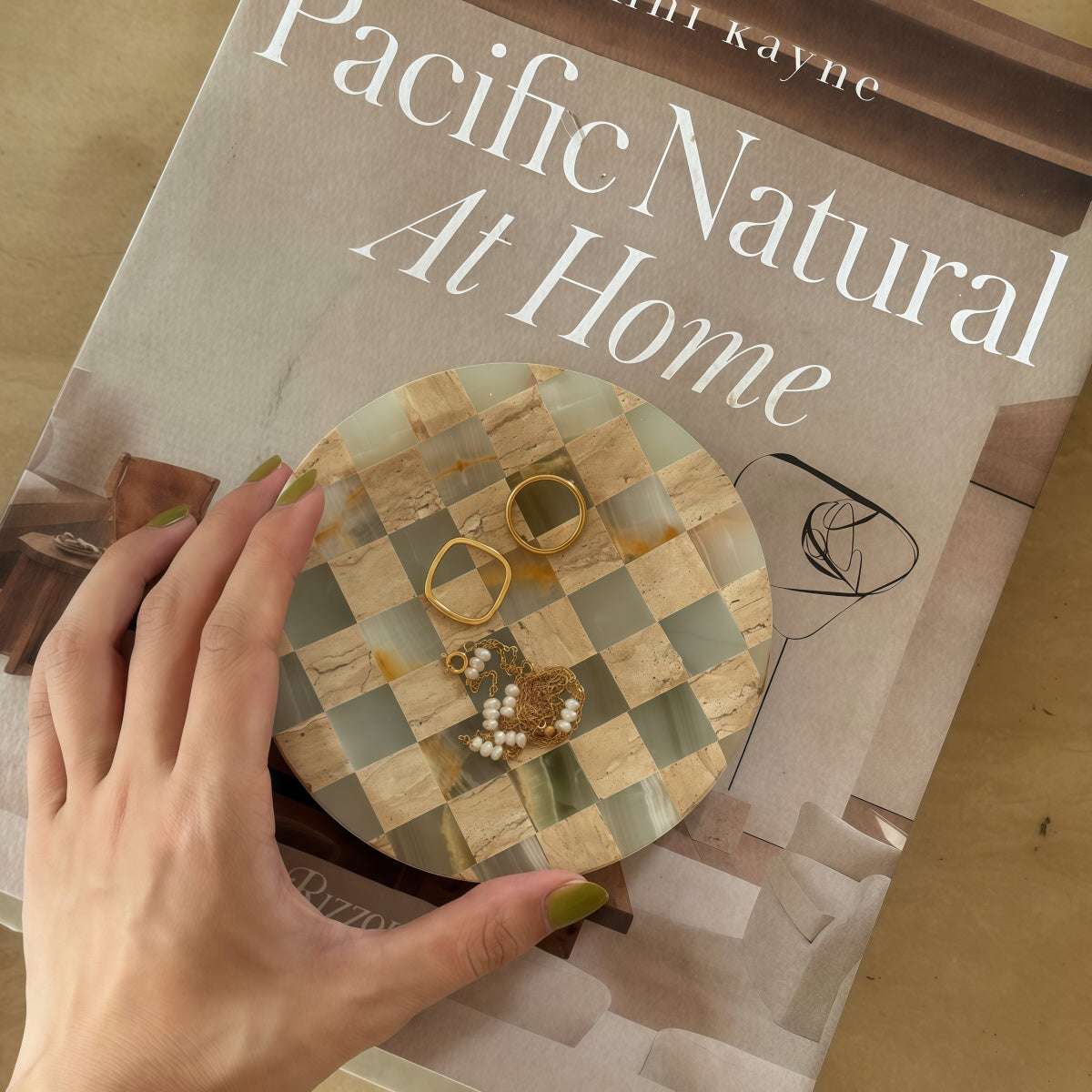 Affordable Luxury stone jewelry tray with handmade mosaic checkerboard inlay and rounded edges, holding rings and beads