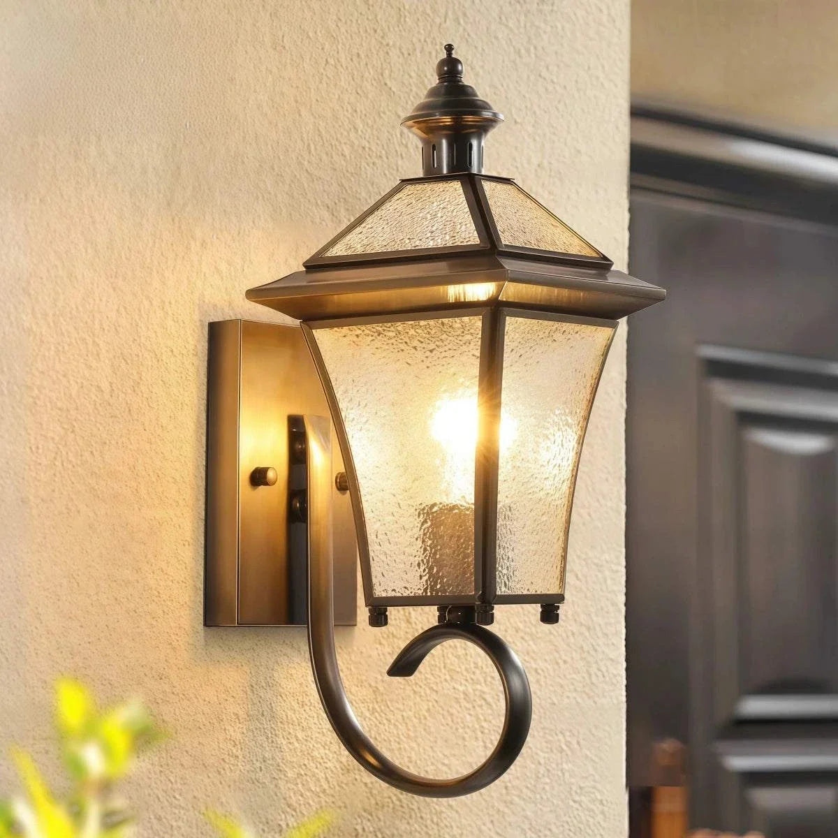 All-Copper Wall Light in antique copper with textured glass, lantern design, and decorative curled arm
