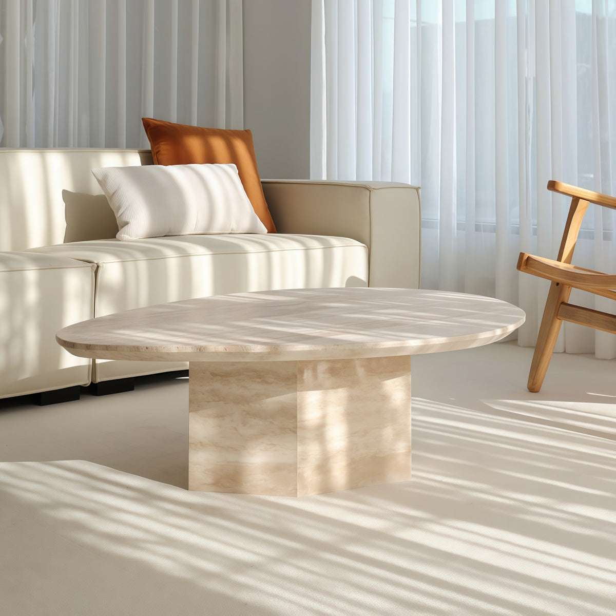 Natural Yellow Travertine coffee table with an irregular oval top, pale veining, and sturdy rectangular stone base