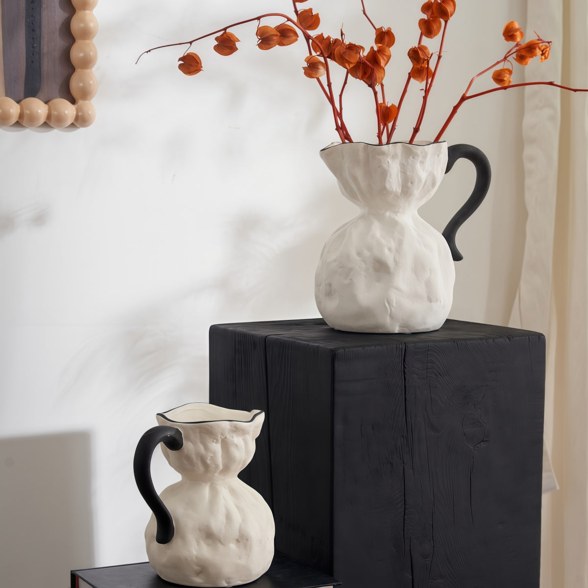 Irregular Ceramic Vase set in textured white ceramic, sculptural pitcher shapes with contrasting black handles and rims