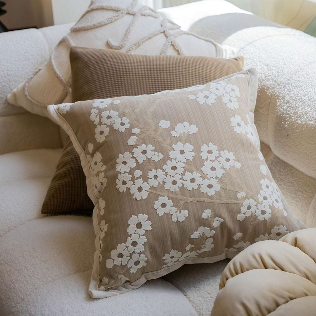 French-Style Embroidered Throw Pillow in taupe blended fabric, with white floral embroidery and a square shape.
