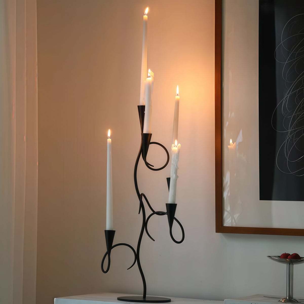 Candle holder in Black Wrought Iron with branch-shaped frame, curled arms, and multiple white taper candles