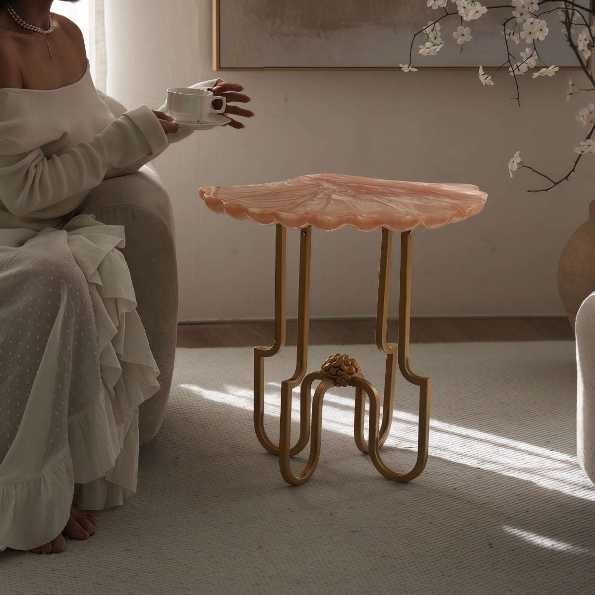 French Vintage-Style side table with a coral pink translucent shell-shaped resin top and ornate gold metal legs