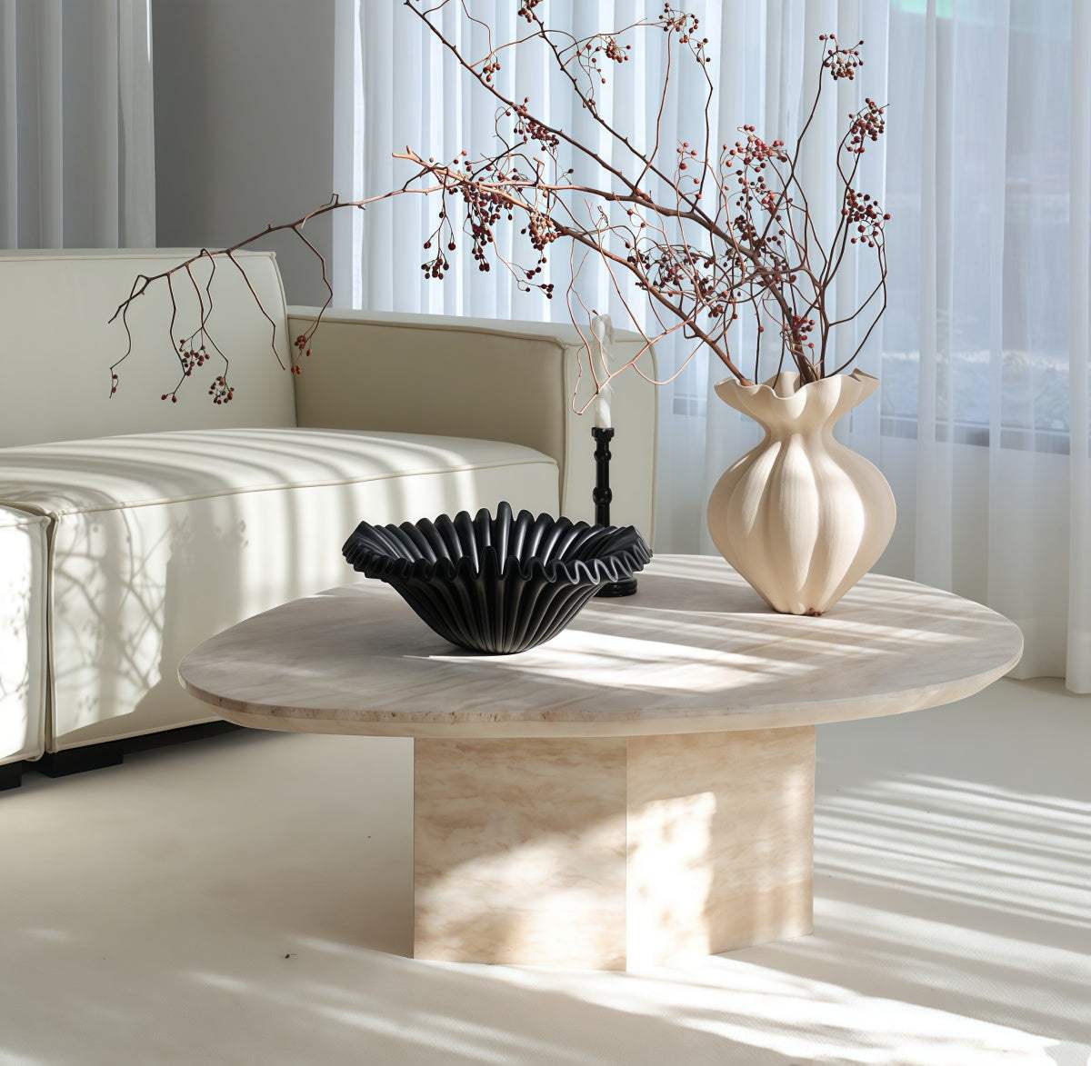 Natural Yellow Travertine coffee table with an irregular oval top, warm veining, and sturdy rectangular stone base