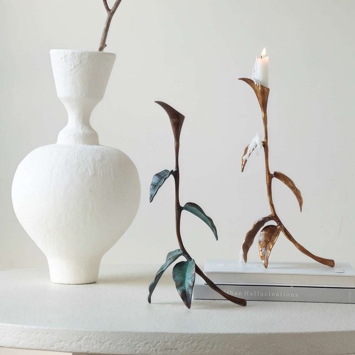 Cast Bronze Calla Lily candle holder with sculptural bronze stems, curved leaves, and a taper candle cup