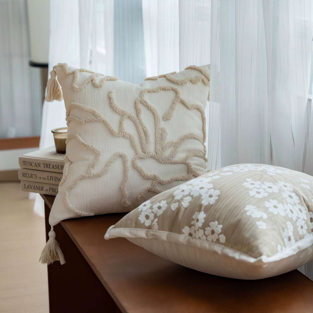 French-Style Embroidered Throw Pillow in cream with raised floral embroidery, tassels, and a second beige floral-print cushion