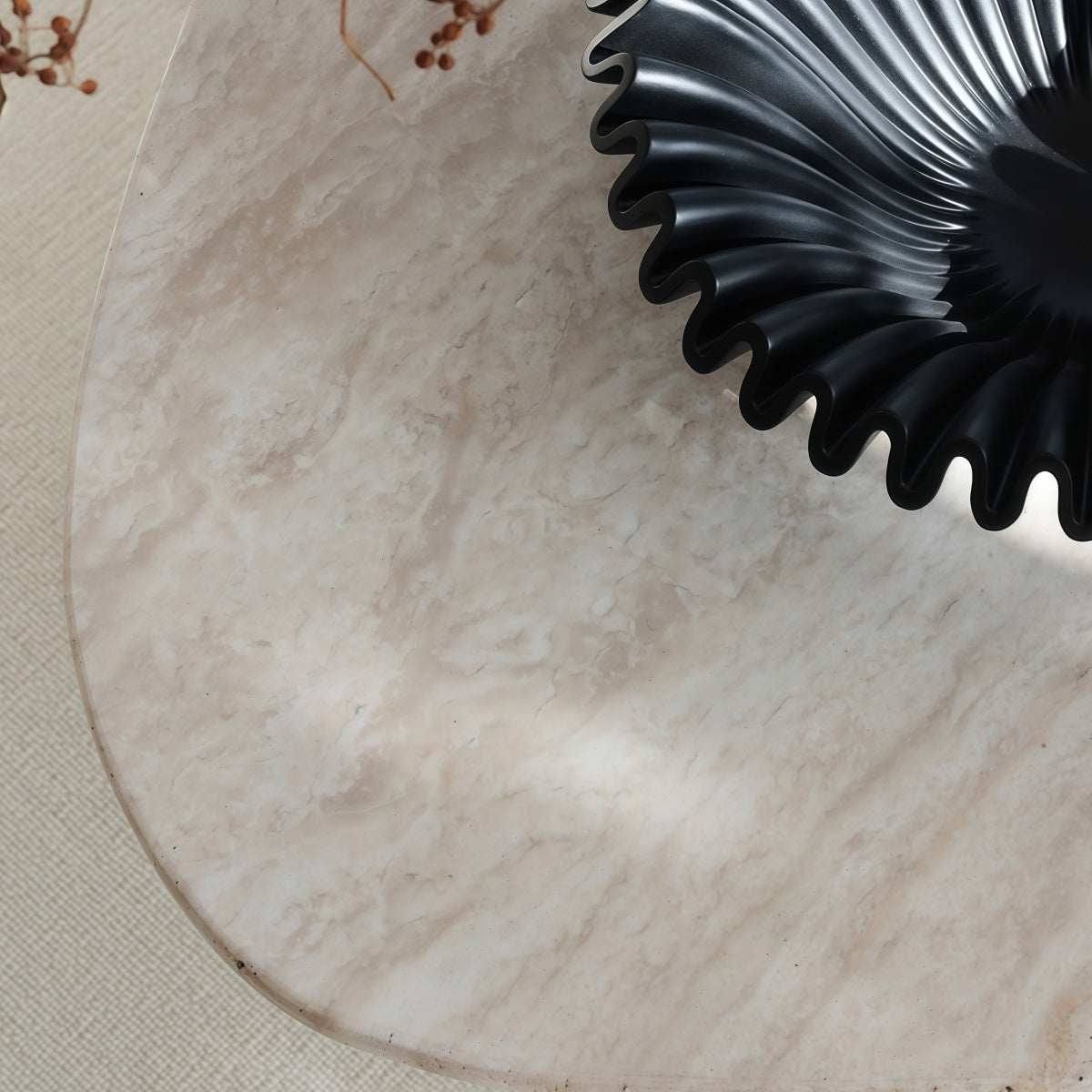 Coffee table with Natural Yellow Travertine top, pale veining, and an irregular oval shape with rounded edges