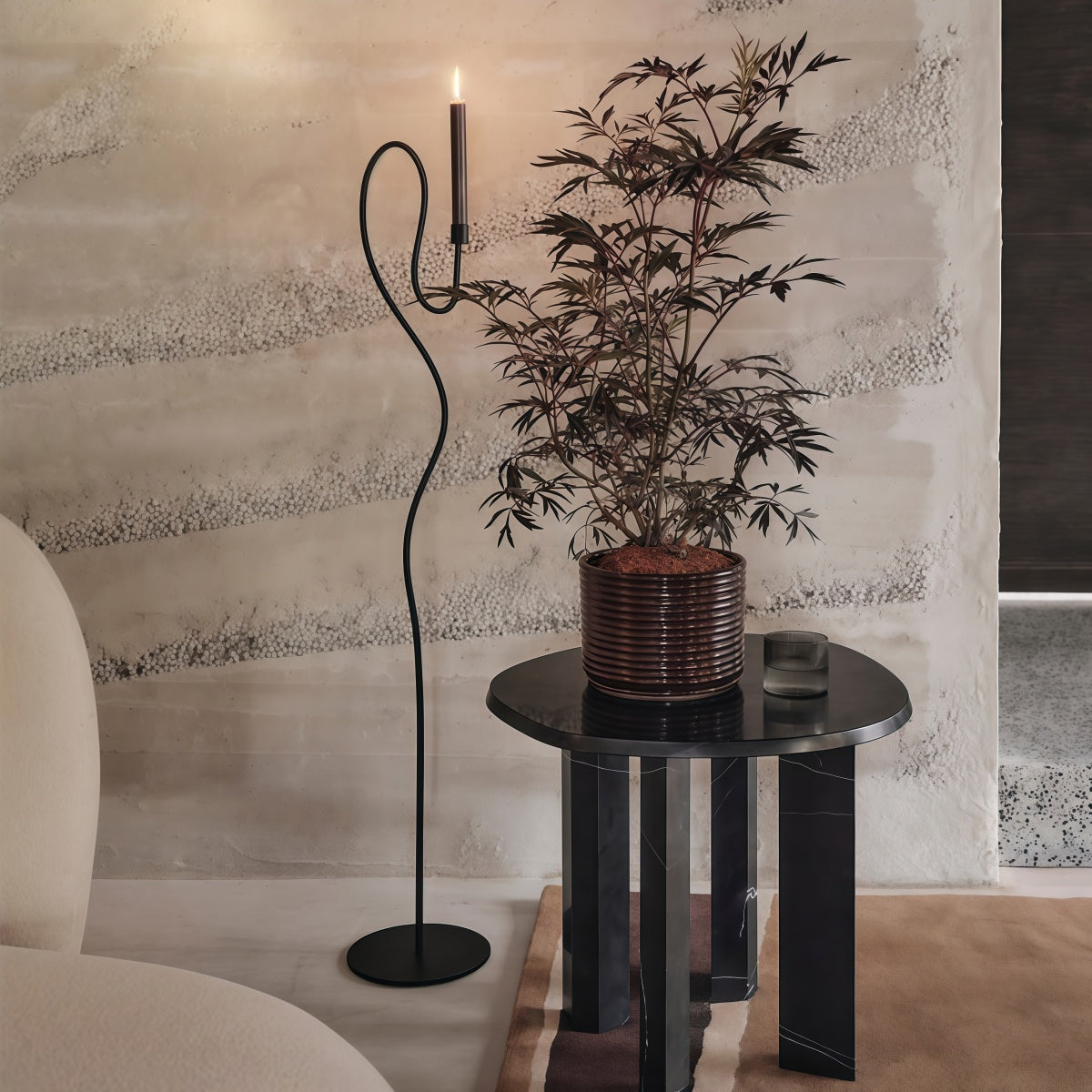Dancer-Themed Floor-Standing Candle Holder in black iron, with a slender wavy stem, curved handle and candle cup.