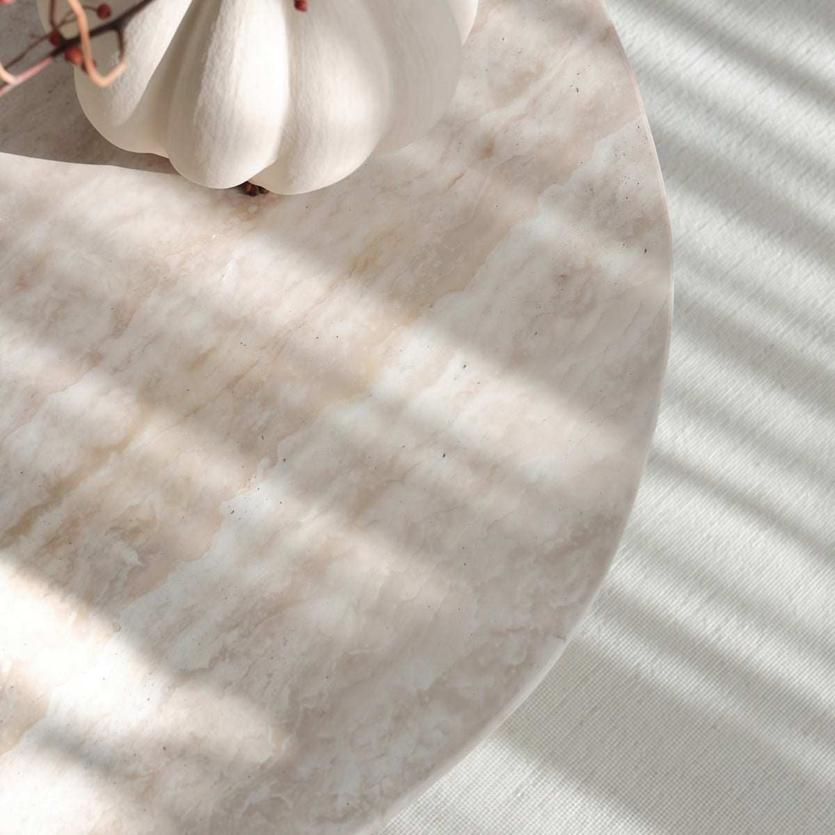 Natural Yellow Travertine coffee table with an irregular oval top, pale veining, and softly rounded edge