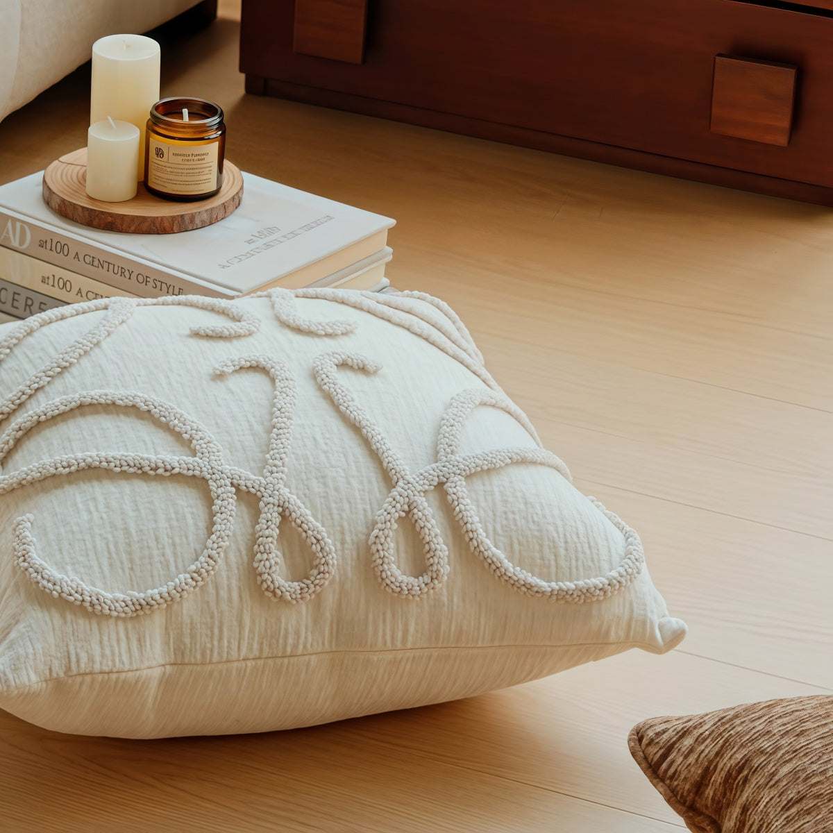 French-Style Embroidered Throw Pillow in ivory textured fabric, featuring raised white looping embroidery and a square shape.