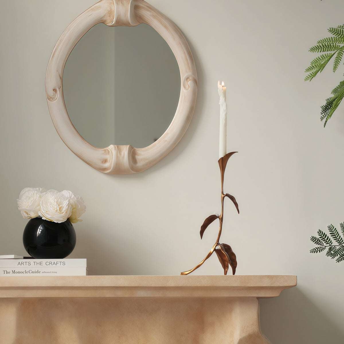 Cast Bronze Calla Lily candle holder with a slender bronze stem, curved leaves and tall white taper candle