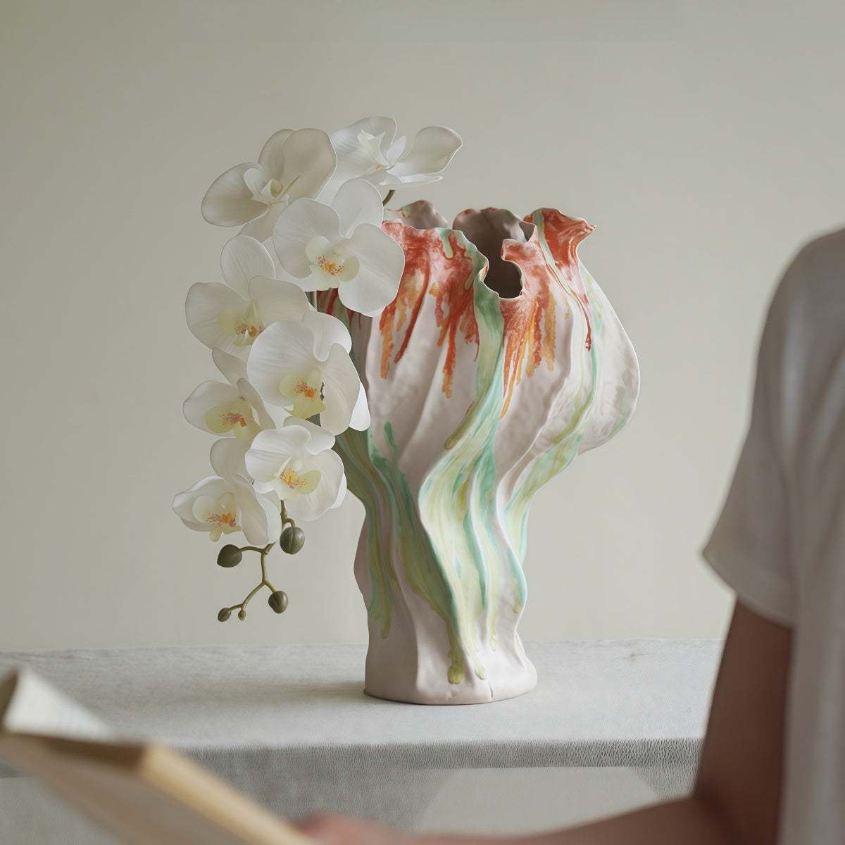 Handmade Pink Retro-Style Vase in ceramic with an irregular sculptural form, flowing green and rust patterns, and ruffled rim